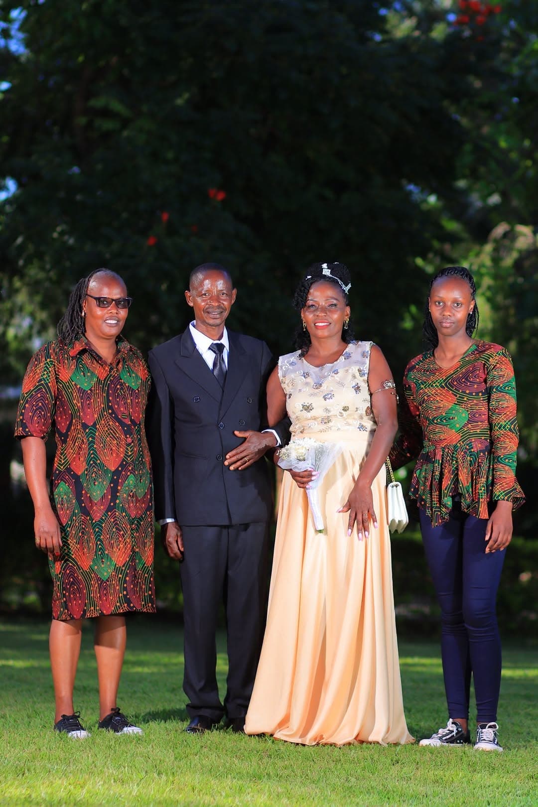 Bride and groom with two guests in printed outfits