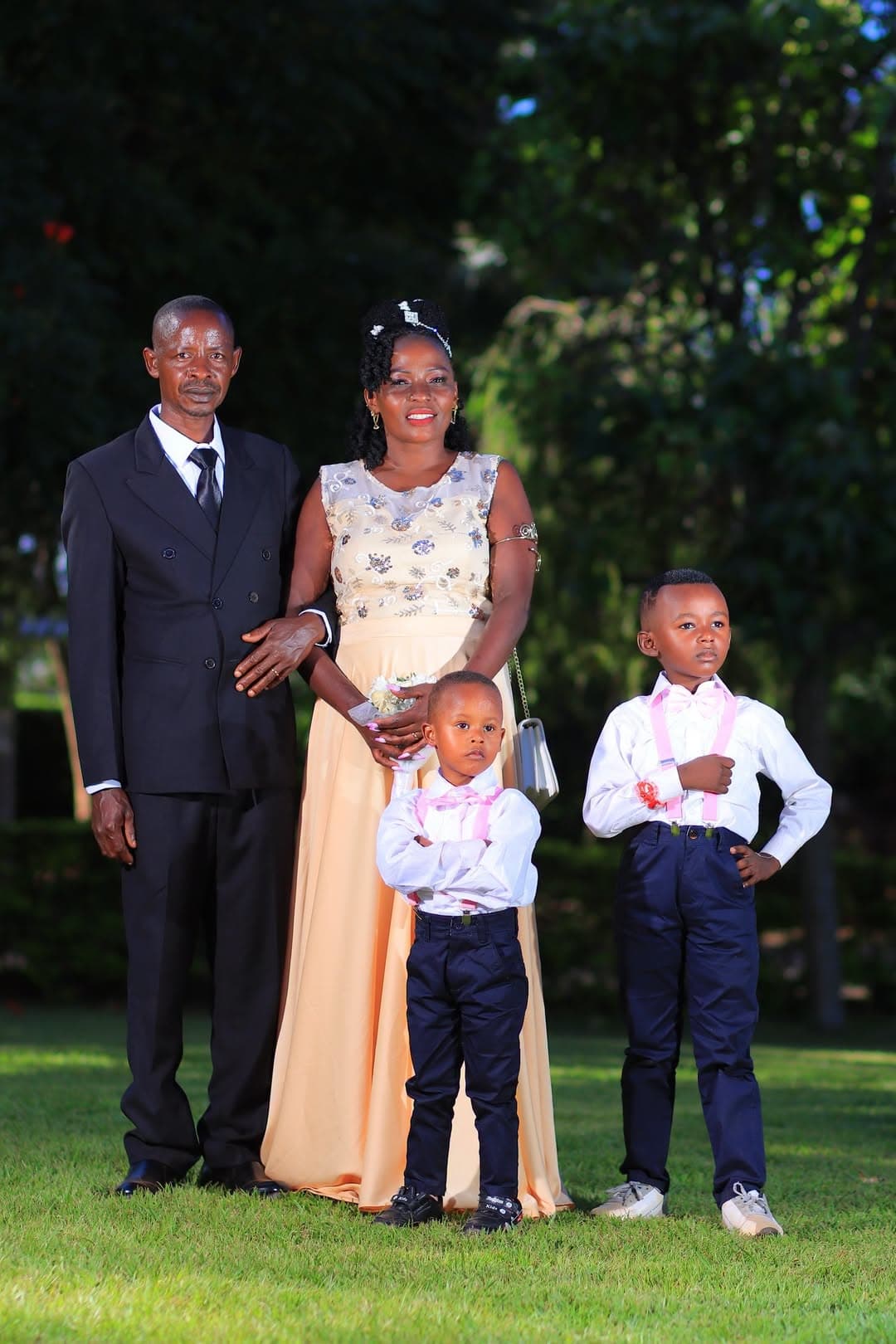 Bride and groom with two young pageboys in waistcoats and bow ties