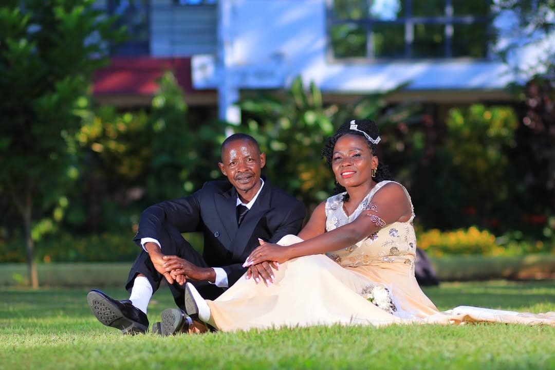 Couple sitting together on the lawn, the bride in a champagne gown and tiara
